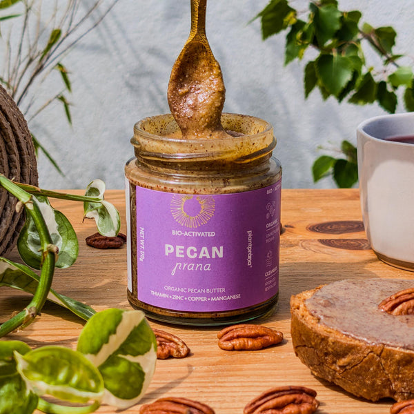 Organic Pecan Butter – activated, on toast with a cup of tea and surrounded by pecans