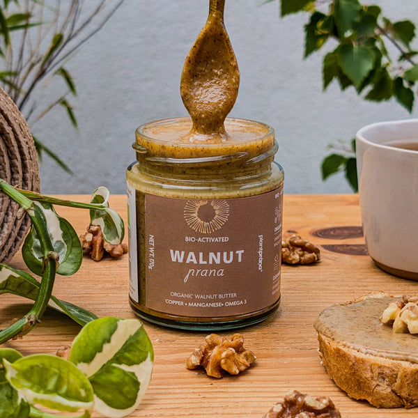 Organic walnut butter with a spoonful on top  - plant prana